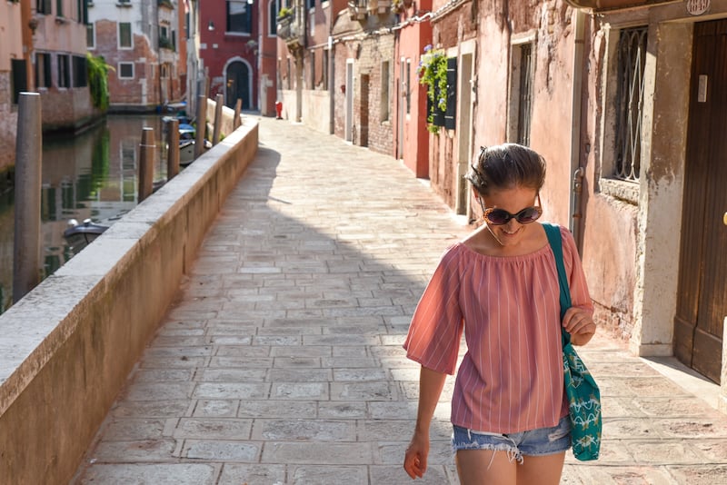 solo female traveler walking around Venice, Italy